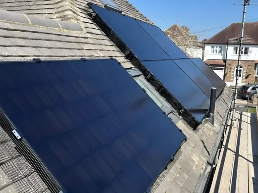 Black panels laid across a slate roof